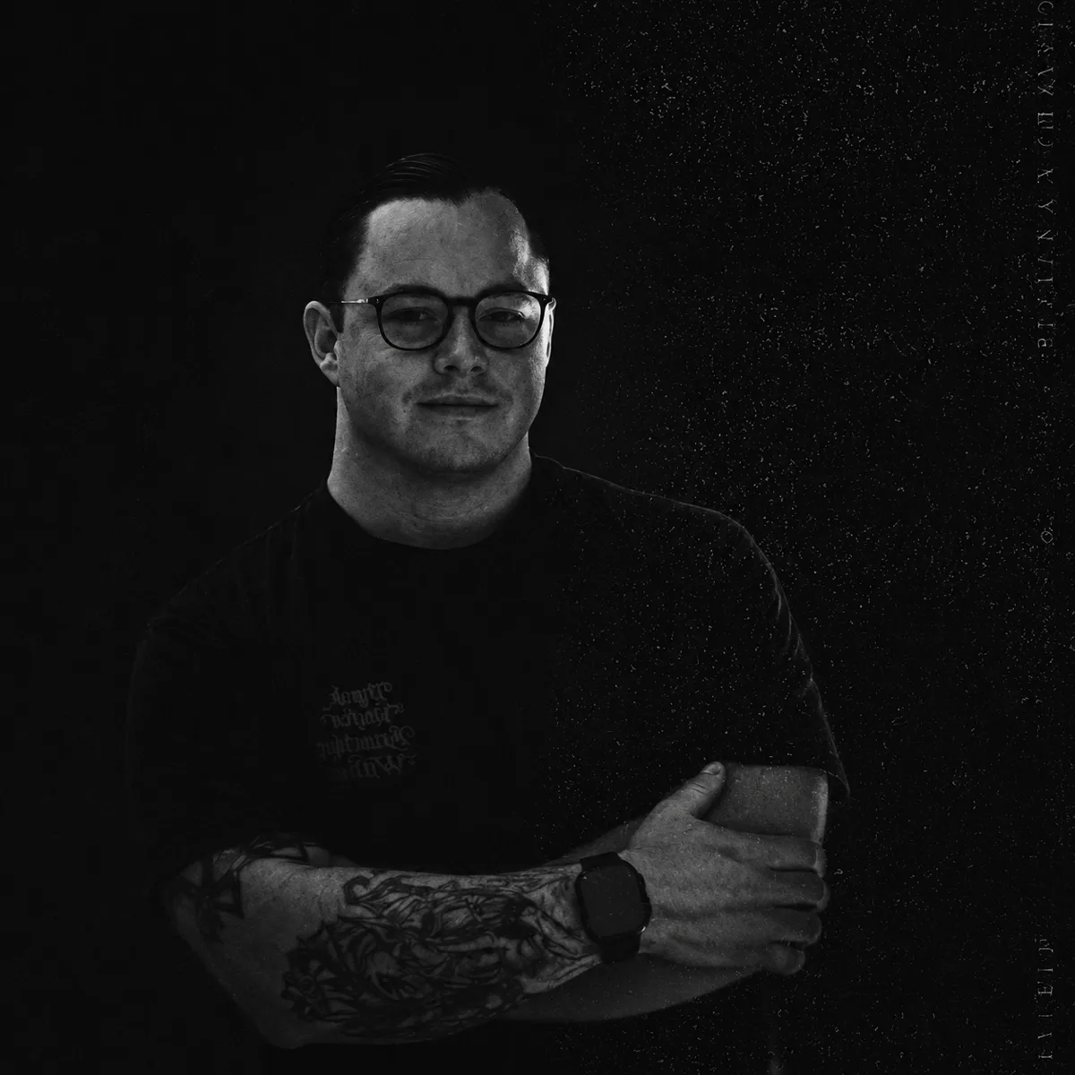 Jay in black and white, arms crossed